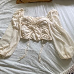 Crème colored, long sleeve crop top